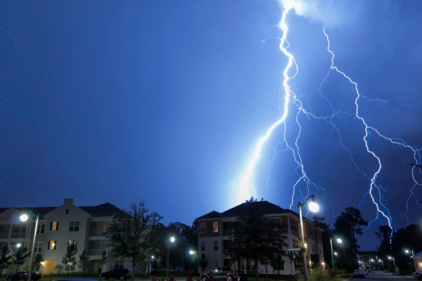 lightning strike on top of a house during storm