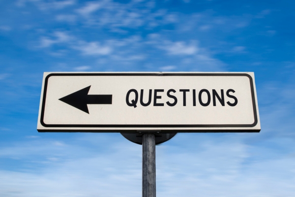 questions written on a road sign depicting FAQS about Condensing vs. Non-Condensing Boilers
