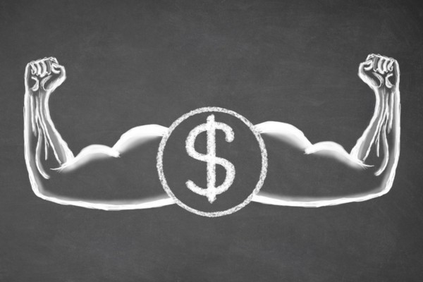 muscular arms and dollar sign doodled on a chalkboard depicting dollar strength