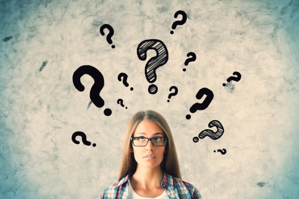 woman looking up with question mark doodles depicting FAQs about water in oil tank