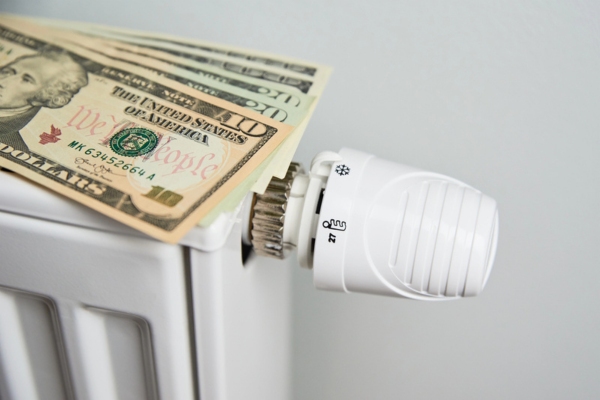oil heating radiator with dollar bill depicting saving on heating oil cost