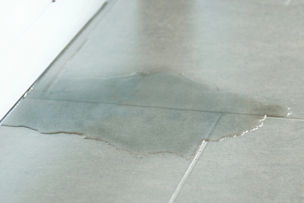 water leak on the floor depicting furnace leak