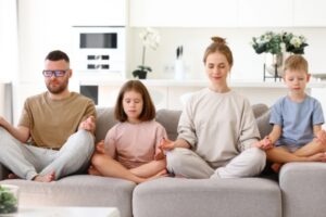 family of four meditating at home depicting clean indoor air quality