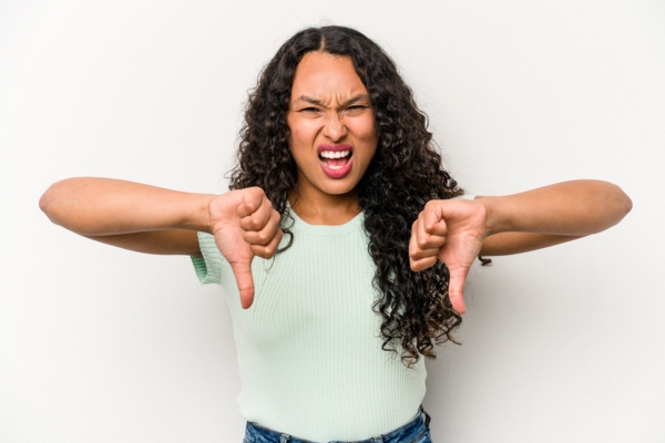 young woman with two thumbs down disputing the myth about HVAC Maintenance