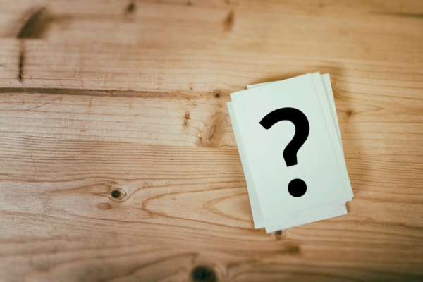 question mark on a stack of paper depicting Signs of Leaky Air Ducts FAQs