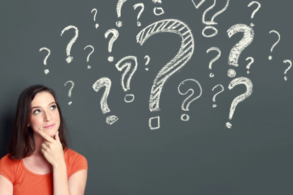 woman looking at question mark doodles on a chalkboard depicting Air Conditioning in Public Spaces FAQs