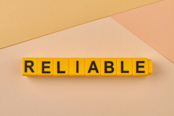 Reliable word spelled using yellow plastic letter cubes depicting air conditioner