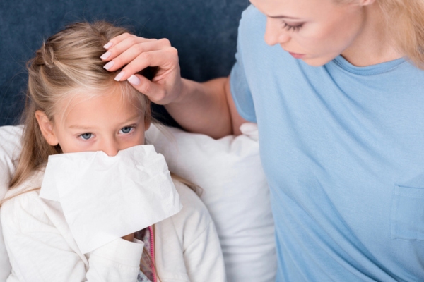 mother taking care of daughter who is feeling sick